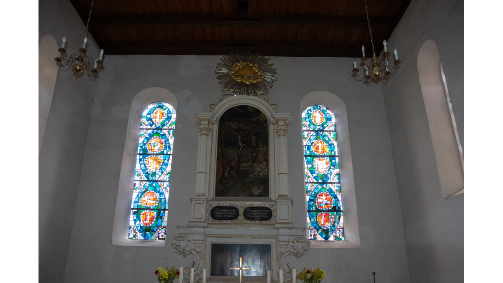 Das Altarbild mit zwei Kirchenfenstern
