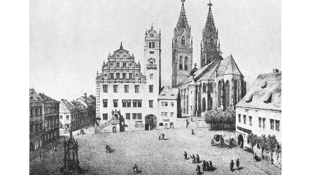 Eine historische Abbildung von St.Aegidien, dem Rathaus von Oschatz und dem Brunnen um 1850.